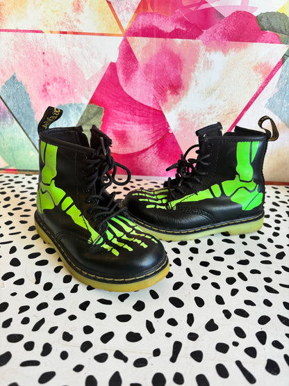 Doc Martens black leather boots with glow in the dark neon green skeleton foot bones. Size 10.