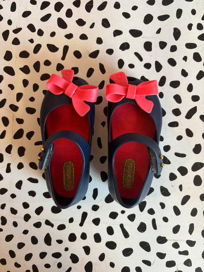 Mini Melissa blue shoes with Velcro strap & bright pink bow. Size 6.