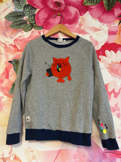 Toca Boca grey sweatshirt with embroidered orange cat singing to music. Size M (8/10)