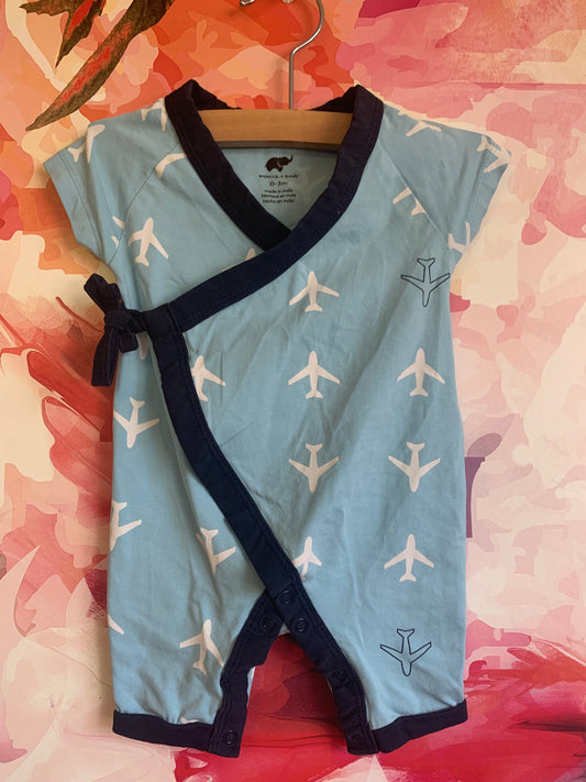 Monica & Andy blue kimono tie short sleeve one piece with white planes. 95% organic cotton 5% spandex. Lead, phthalate & flame-retardant free. Size 0-3m