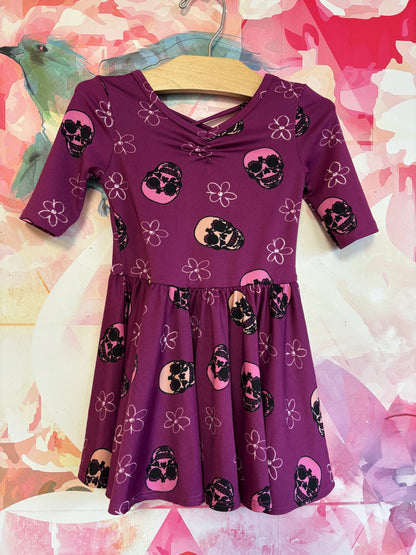 Dot Dot Smile purple short sleeve swing dress with flowers & skulls. Size 2T.