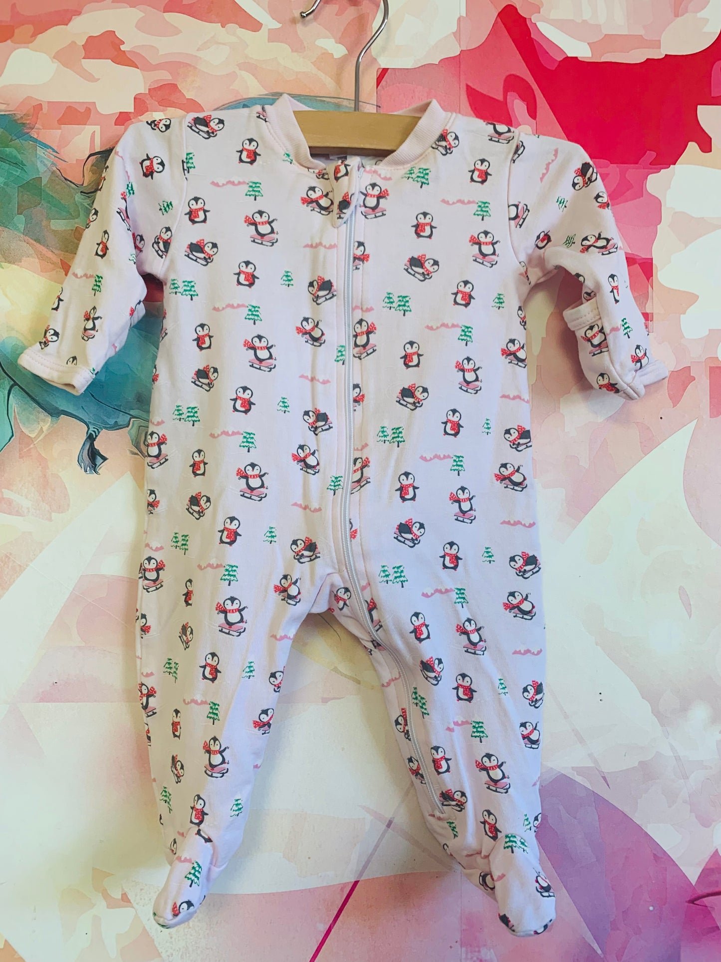 kissy kissy pink long sleeve romper with penguins & snowy pine trees. Size Newborn.