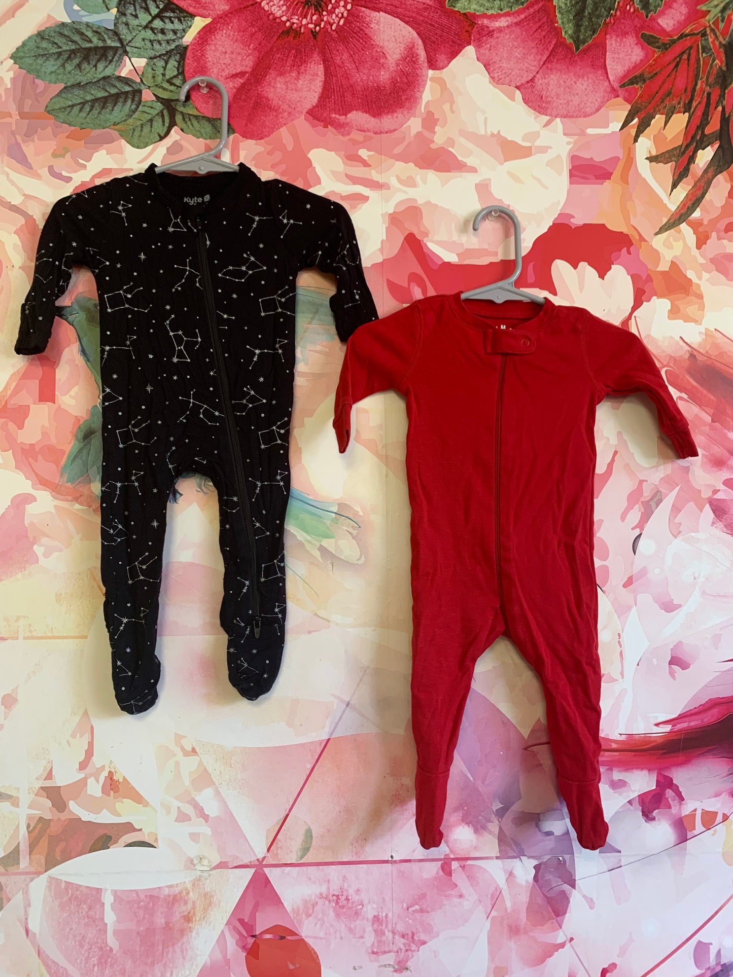 Kyte Black long sleeve romper with white constellations. Primary Red long sleeve romper. Size 0-3m