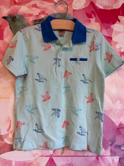 Maximus Rex light blue short sleeve polo with orange and blue dinosaur outlines. Size 7.