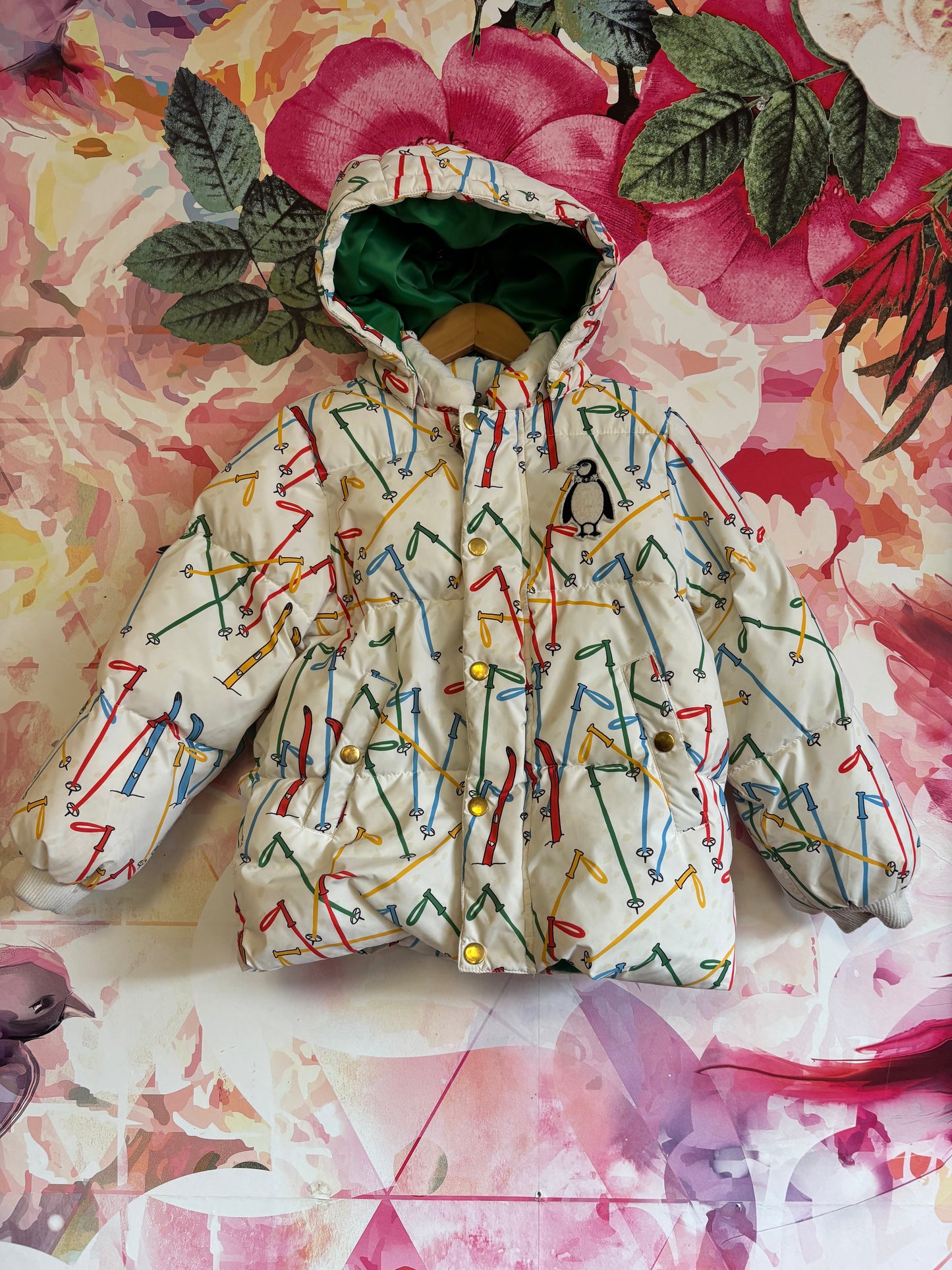 Mini Rodini cream puffy coat with colorful ski poles and hood. Green lining. Size 6/7.