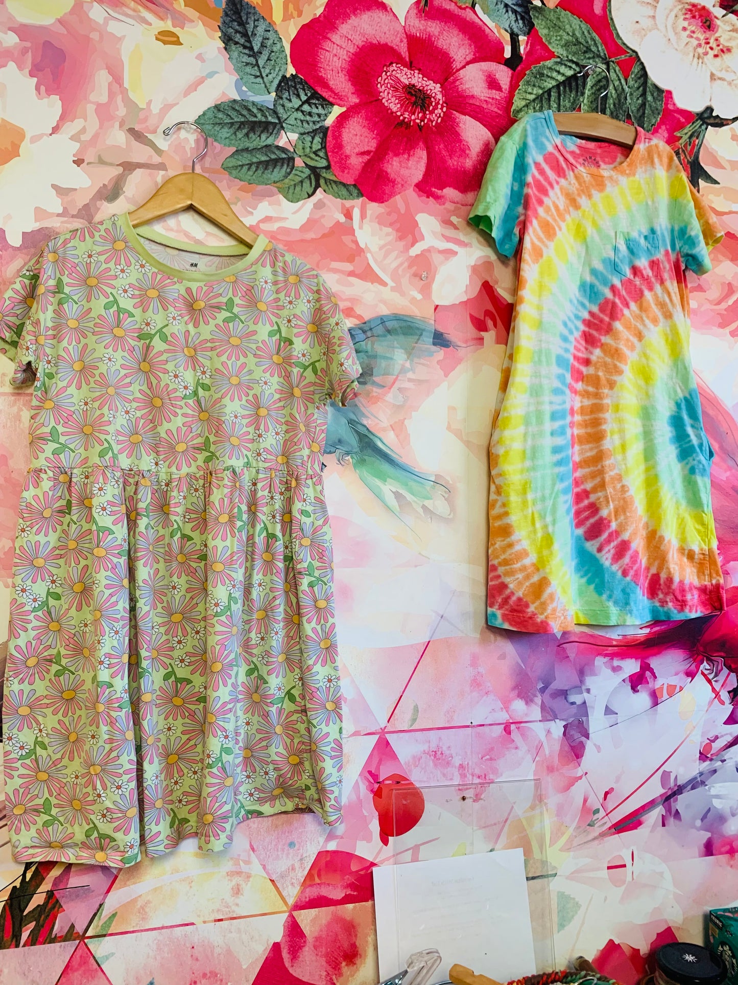 Two summer dresses. H&M short sleeve green, pink, purple, orange floral dress. Primary rainbow tie dye short sleeve dress with side pockets. Size 10.