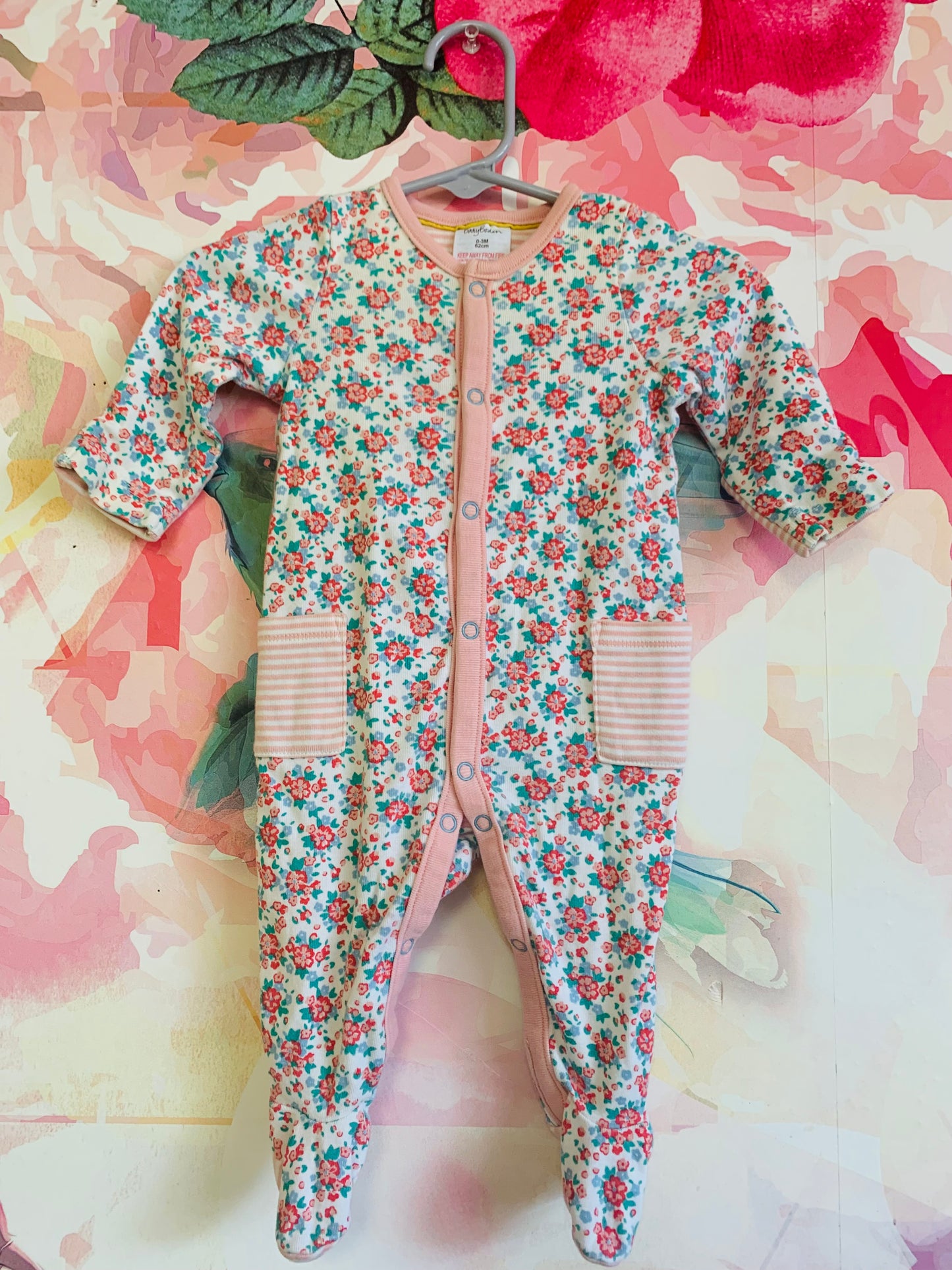 Baby Boden red, pink, green floral long sleeve footed romper with snaps. Pink/white stripes on pockets & wrists. Size 0-3m