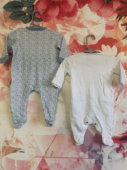 Two long sleeve rompers with snaps. Rock A Bye Baby blue & white flower romper. Size 3-6m. Next Baby white romper. Size 3m.