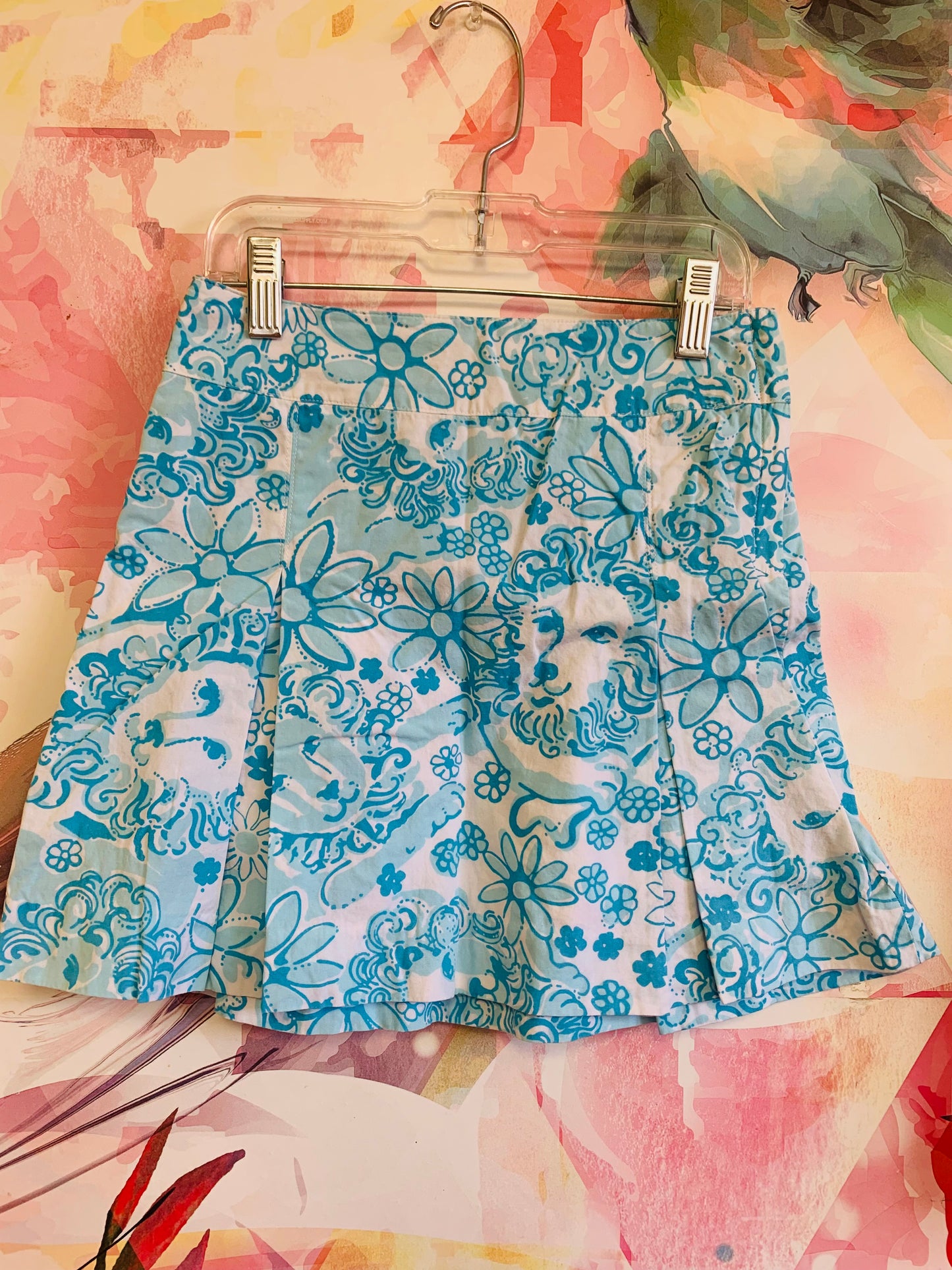 Lilly Pulitzer blue/white pleated & side zipper skirt with lion faces & flowers. Size 10.