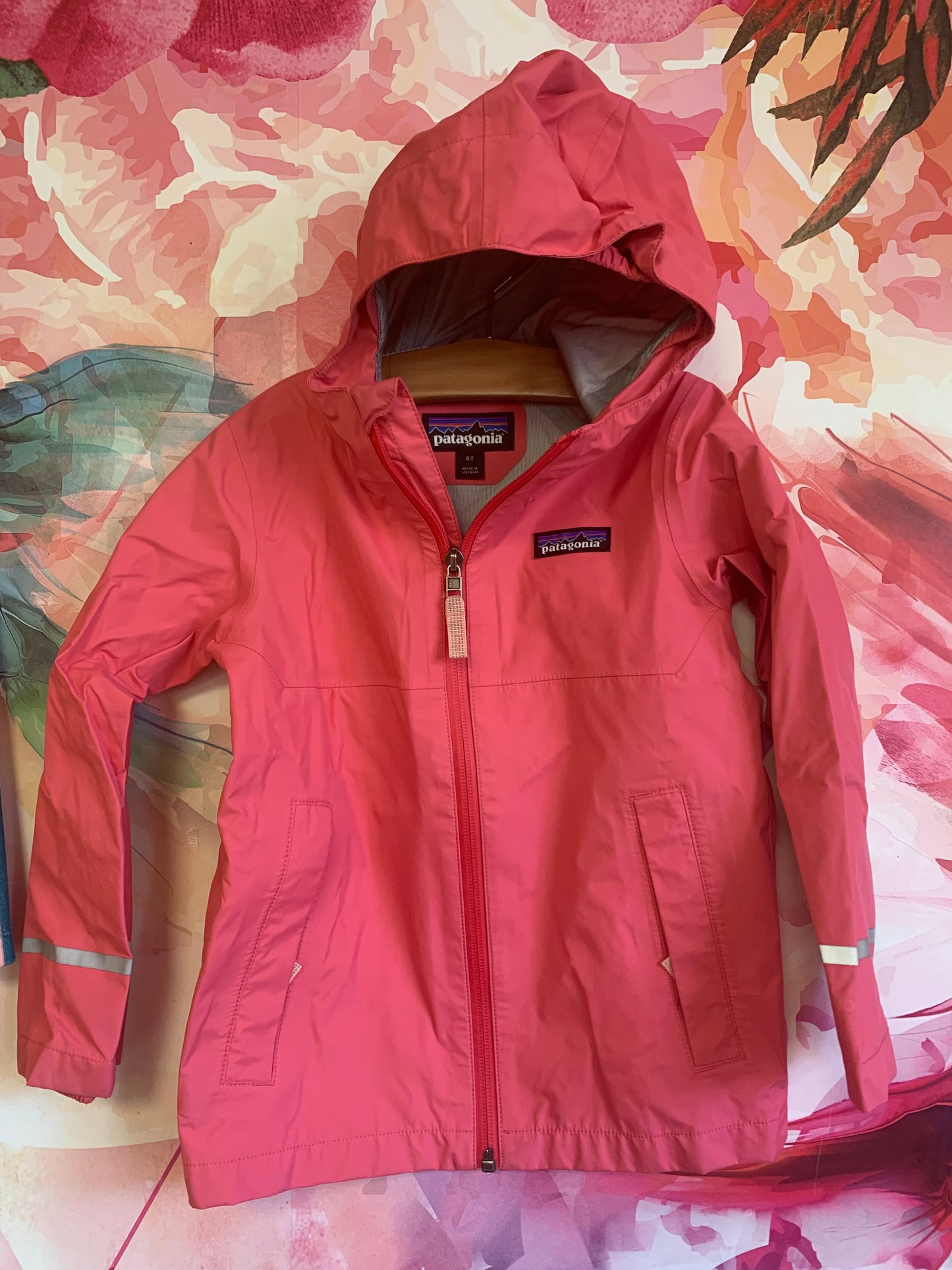 Patagonia pink raincoat with hood and reflective stripes. Size 4T.