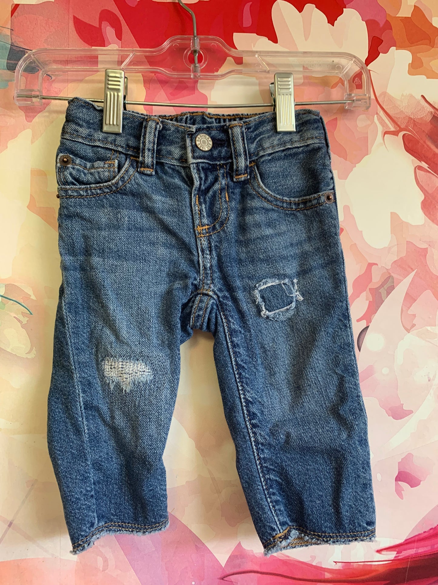 Baby Gap blue jeans with distressed knees and snap waist. Size 3-6m.