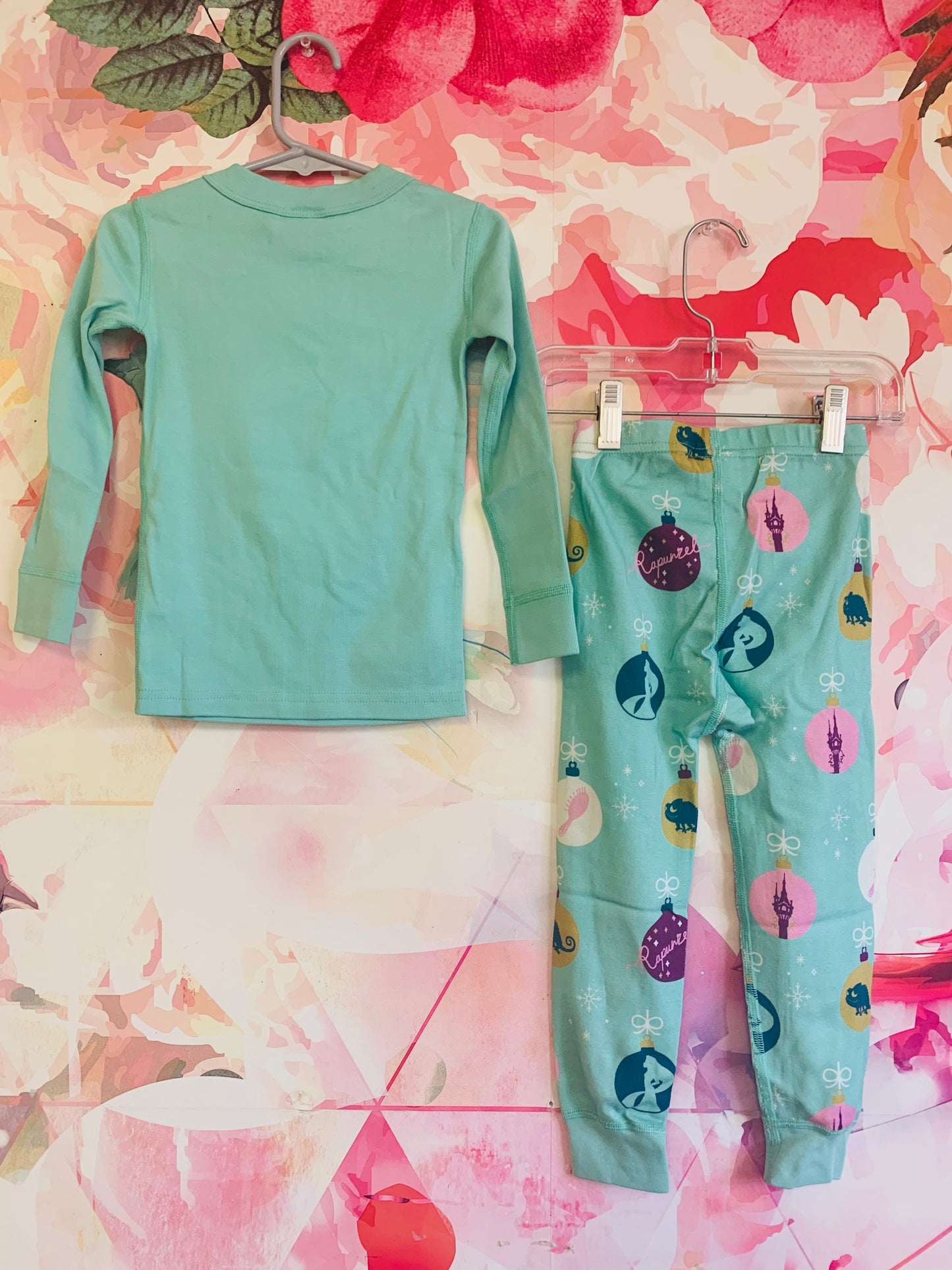 Hanna Andersson/Disney light blue long sleeve pj set. *New With Tags*. Rapunzel in purple dress on shirt, ornaments on pants. Size 3T