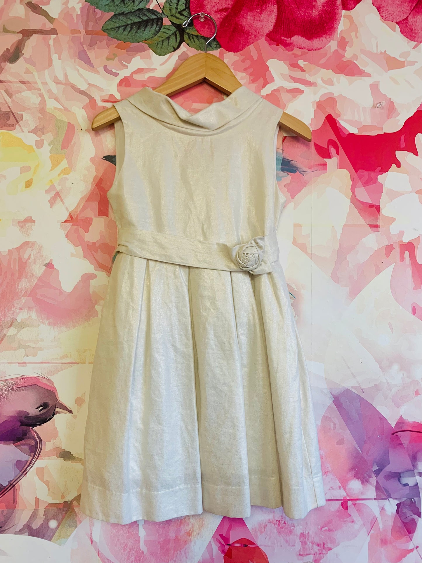 Mayoral golden shimmery ivory sleeveless dress with full lining, pleats and low zipper back. Waist belt with rose on front & adjustable snaps on back. Size 6.