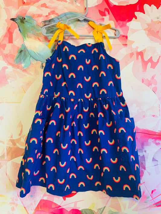 Hanna Andersson blue dress with rainbows, front pockets & yellow shoulder ties. Size 6/7