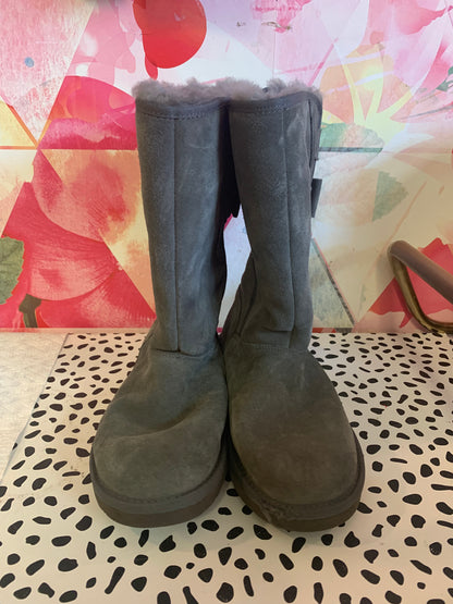 Ugg grey tall winter boots with two bows on back. Size 6.