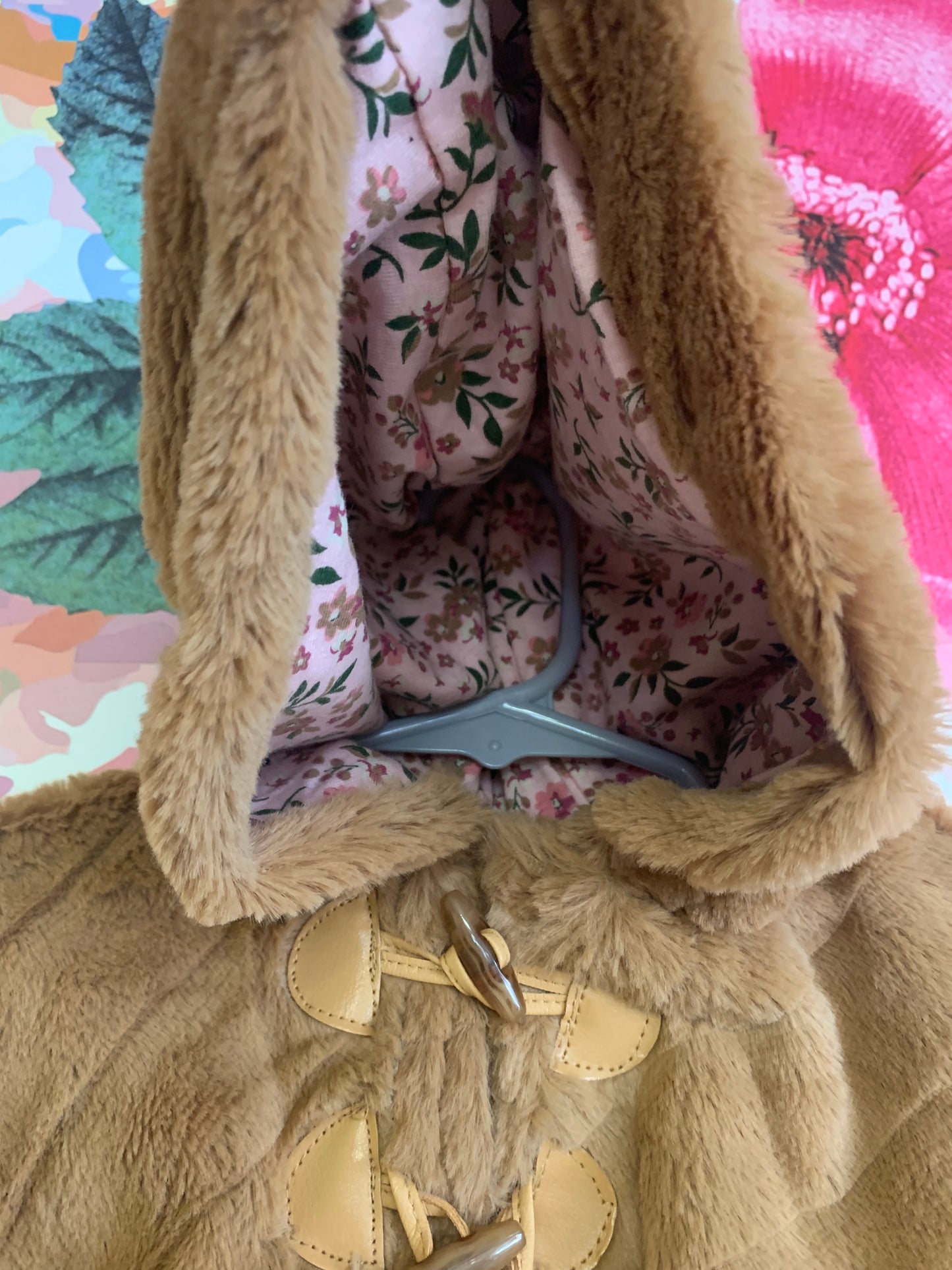 Little Lass light brown faux fur poncho with hood and side snaps. Pink floral lining. Size 18m.