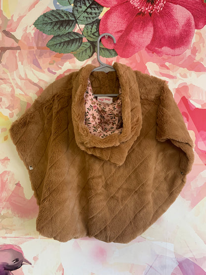 Little Lass light brown faux fur poncho with hood and side snaps. Pink floral lining. Size 18m.