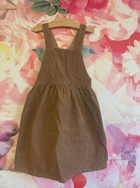 H&M light brown corduroy apron front dress with criss cross straps in back. Size 7.