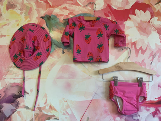 Hanna Andersson pink two piece swimsuit with red strawberries and matching hat. Size 0-3m