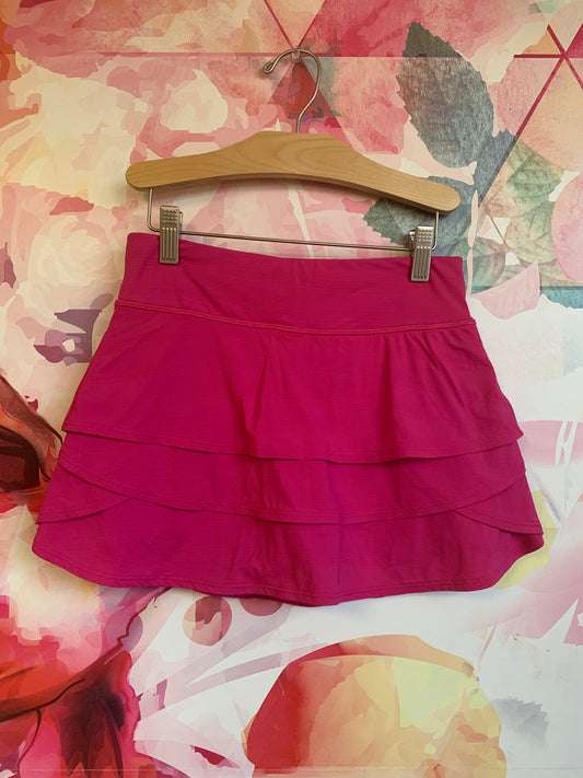 Athleta Girl fuschia skort. Zipper pocket on back. Extra pockets on shorts underneath. Size 12.